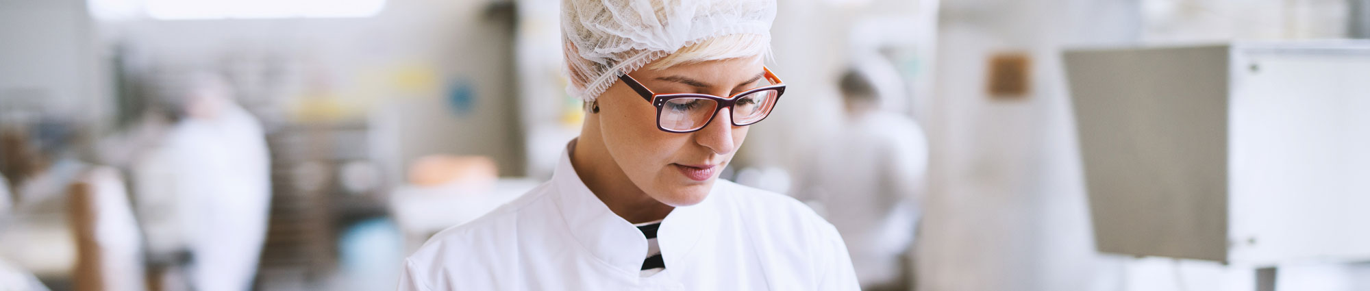 Lady preparing food in factory