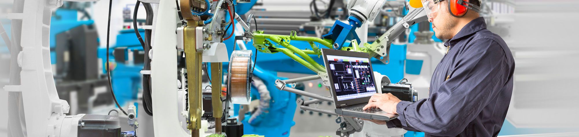 Staff member using computer in automotive factory