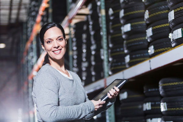 Female staff member next to shelves of car tyres