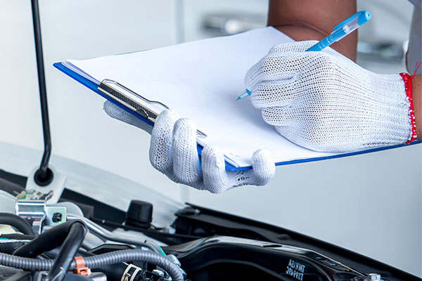 Compliance manager checking car engine