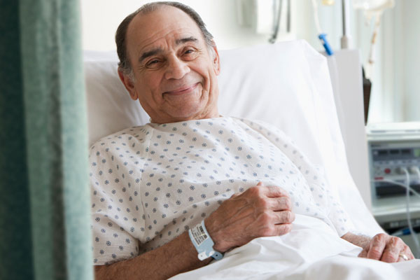 Elderly man in hospital bed