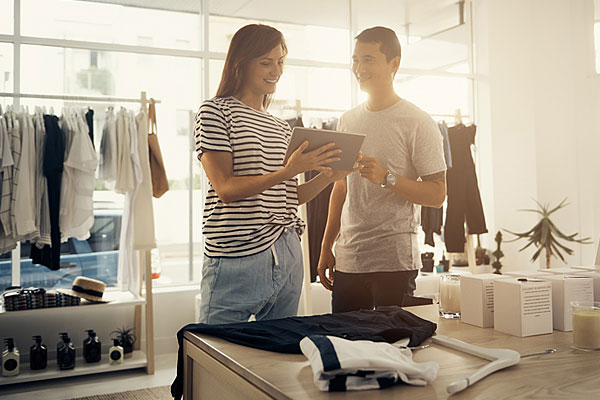 Staff member helping customer in clothing store